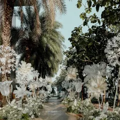The magical walkway for the 'White Wonderland' event. We lined the path with giant, handcrafted dandelions and other paper flowers, creating an ethereal, dreamlike journey for the guests.