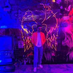 A stylish shot from a Goa after-party. The neon lights and graffiti wall set the perfect mood for a night that never ends.