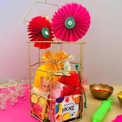 This Holi hamper, presented in a gold wire cage, is decorated with bright paper fans. It's a fun and festive gift, perfect for sharing the joy of the festival of colors.