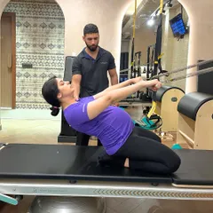 We specialize in prenatal Pilates to support mothers-to-be. This client, at 8 months pregnant, demonstrates how our tailored workouts help maintain strength and comfort throughout pregnancy.