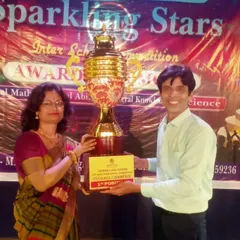 Our founder presenting the first-place trophy at the "Sparkling Stars" Inter-School Competition. We are proud to support and celebrate young talent.
