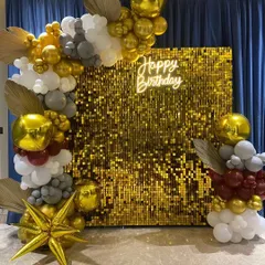 A wider shot of the gold sequin backdrop, showing the full scale of the balloon decoration. The arrangement elegantly frames the shimmer wall, making it an impressive centerpiece for a milestone birthday or a glamorous bachelorette party.