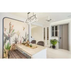 Dining spaces should feel special. For this project, I used a stunning tropical wallpaper to create a feature wall, framed to look like a piece of art. The Italian marble dining table, paired with plaid-upholstered chairs and a bench, adds a layer of timeless elegance, all under a modern branching chandelier.