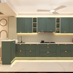 An elegant kitchen design in a deep sage green, featuring classic shaker-style cabinets and gold hardware. The layout includes a breakfast bar extension, making it a social hub as well as a cooking area.
