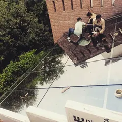 Our skilled installation team is seen here carefully fitting and sealing the large glass panels for a sunroom roof. Precision is key to creating a seamless, watertight surface that reflects the sky.