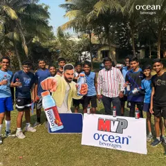 The boys' team posing with our sponsor's banner at the Winter Basketball League. Building a community involves everyone, including our partners who support youth sports.