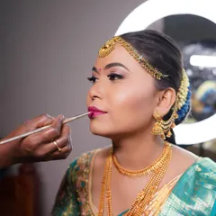 A shot of me in action, applying the perfect lip color for Arpitha. This close-up shows the precision and care I take with every step.
