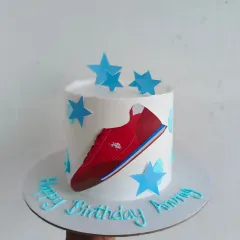A cake themed around the USPA brand for a boss's birthday, featuring the shoe logo.