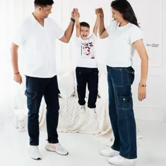 A fun and energetic family moment! Lifting up the little one always brings out the biggest smiles and creates a photo full of life and happiness.