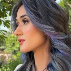 A side profile of the ash, lilac, and blue hair color. This angle shows the subtle transition between the different cool tones and how they create a multi-dimensional effect.