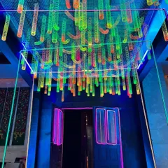 The vibrant entrance to a neon-themed party for Round Table India. We created a ceiling installation using hundreds of colorful, glowing slinky toys to produce a playful and energetic welcome for guests.