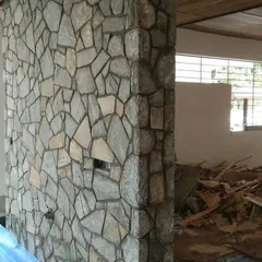 A stone-clad pillar during a renovation project. The natural stone texture provides a great contrast to smooth painted walls.
