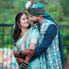 A beautiful candid shot of the couple sharing a look. The bride's light blue saree and the groom's matching attire create a harmonious and visually pleasing portrait.