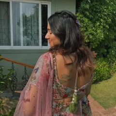 A detailed shot of the back of this beautiful hairstyle. The intricate braid and floral accessory add a unique and personal touch.