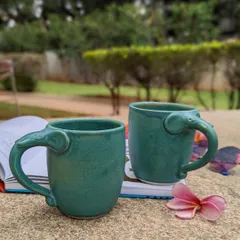 Here are my beloved Periyar elephant mugs, captured during a quiet moment outdoors. Handcrafted by studio potters, the handle is shaped like a trunk, making each sip a delightful experience. They are a perfect example of how I blend unique design with everyday use.
