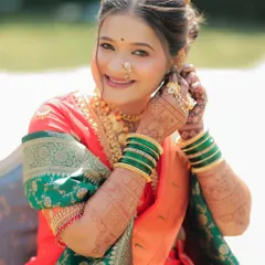 Another shot of this beautiful bride, adjusting her earring and giving a perfect view of her intricate bridal mehndi.