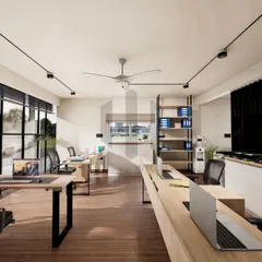 This view of the Noir Oak office highlights the open workstation layout. The desks are arranged to foster quiet connection, close enough for collaboration but spaced for individual focus. The large window and track lighting ensure the space is always bright and visually clean.