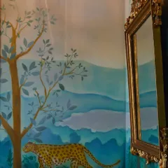 The hand-painted cheetah mural in this powder room is a perfect example of art-infused design. The soft, layered landscape creates a sense of depth and whimsy, turning a small, functional space into an unforgettable experience.
