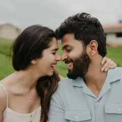 A moment of pure, unscripted laughter. Nishant and Aishwarya's pre-wedding shoot in a serene meadow is all about capturing their natural connection and joy.