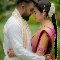 A quiet and intimate embrace with the couple's foreheads touching, set against a soft green background. This portrait focuses purely on their emotional connection.