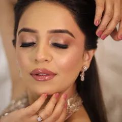 A close-up on a soft glam look, highlighting a flawless, skin-like base with a natural radiance. The eyes have a pink-toned shimmer, and the lips are a plush nude, creating an effortlessly luxe feel.