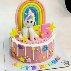 A magical rainbow unicorn cake for Aarya's 5th birthday. This design features a hand-molded unicorn, a colorful rainbow, and fun drip details for a truly enchanting celebration.