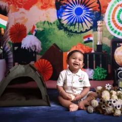 A happy smile for Independence Day! This little patriot is sitting in our festive setup, complete with tricolor decorations and a miniature tent, celebrating the spirit of the nation.
