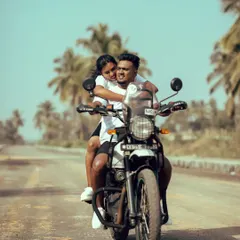 A dynamic shot of a couple enjoying a ride on their Royal Enfield. This captures the thrill and excitement of their journey together.