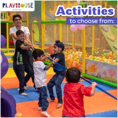 A group of boys and a staff member engage in a friendly game of tug-of-war on our soft, padded floor mats, ensuring a safe surface for active games.