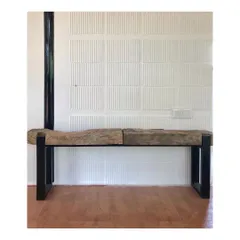 This bench is crafted from a raw, unfinished slab of wood set on a simple metal frame. It's a prime example of using recycled materials to create functional furniture that celebrates the imperfections and beauty of nature.