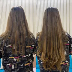 The final result of a keratin glue extension service. The extensions are blended so well that they are indistinguishable from the client's natural hair, just longer and fuller.