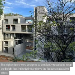 The cascading facade of the new IIM hostel, where higher floors are receded to reduce the building's perceived height. This design choice helps the four-storey structure sit comfortably within the predominantly low-rise campus.