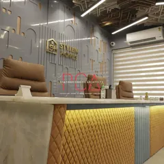 The reception desk at StyleIn Homes features a mix of materials, including a quilted yellow fabric front, a solid surface top, and custom lighting. This serves as a vibrant and welcoming first point of contact for visitors.