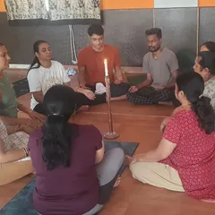 Here, a group practices Jyoti Trataka Kriya, or candle gazing, a powerful yogic technique for improving focus and calming the mind. This is one of the many mindfulness practices I use to combat workplace stress and enhance mental clarity.