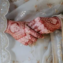 The final stain is just as important as the initial design. I use my own natural henna paste to achieve this beautiful, deep reddish-brown color that looks stunning against the bride's wedding attire.