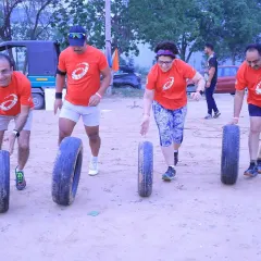 It's not just about running. Our fitness challenges, like this tire-flipping drill, are designed to build functional strength, teamwork, and grit in a fun, high-energy environment.
