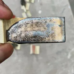 Another glaze test, this time resulting in a metallic, cratered surface. The chemistry of ceramics is full of wonderful surprises.