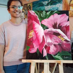 Lakshmi with her stunning large-scale floral painting. Working on a big canvas like this helps students build confidence and learn how to handle composition and color on a more impactful scale.
