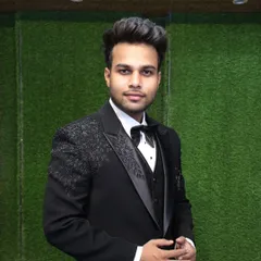 A customer looking dapper in our black three-piece tuxedo. The highlight is the detailed floral sequin work on the shoulder and lapel, which catches the light beautifully.