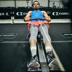 On the rower during a Hyrox competition. This machine is a full-body workout that builds both cardiovascular endurance and muscular strength.