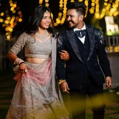A classic portrait of the couple at their reception, looking elegant and happy. The soft lighting and their joyful expressions make this a timeless photo.