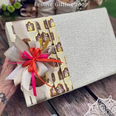 A glimpse into my festive gifting for 2025. This beautifully wrapped box uses a combination of textured paper and a patterned fabric band, finished with a multi-layered bow for a touch of modern Indian luxury.