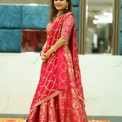 This happy customer is twirling in a dreamy Banarasi lehenga, a perfect blend of tradition and grace.