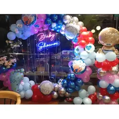 This baby shower setup for a boy was so much fun to create. I used a vibrant mix of red, blue, and silver balloons, a "Baby Shower" neon sign, and lots of cute baby-themed foil balloons to make it super festive.