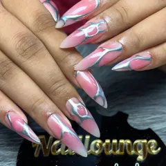 For those who love a bold and edgy look, I create designs like this. This set features long stiletto extensions with a pink base and a raised, metallic silver chrome design for a futuristic 3D effect.