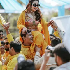 The bride makes a grand entrance at her Haldi ceremony, carried on the shoulders of her family. We capture these high-energy, unforgettable moments.