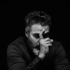 Another angle from our thoughtful series, this frame captures a pensive mood. The interplay of light and shadow across his face tells a story without a single word, a signature of my fine art portrait style.