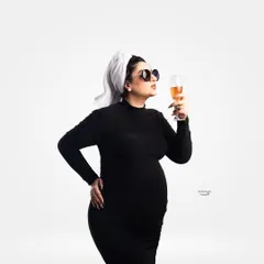 A fun and cheeky concept shoot! The client is styled with a towel on her head and sunglasses, sipping a non-alcoholic drink for a playful 'day off' vibe.