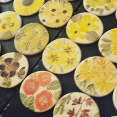 A close up view of my floral coasters, showing the variety of hand painted designs. I never repeat a design, so each coaster is a miniature piece of art. They are a great way to add a touch of handmade beauty to your home.