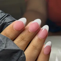 A close-up of the sharp, clean lines on these classic French tips. Perfection is in the details.